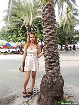 Standing beside tree wearing dress